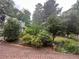 A home with green bushes and colorful plants enhance the curb appeal of this residence at 3 Perthshire Dr, Peachtree City, GA 30269