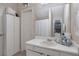 Bright bathroom featuring a large mirror, white cabinets, and ample storage for toiletries and linens at 3130 Jorden Crest Ct, Lawrenceville, GA 30044