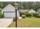 Charming one-story home with a manicured lawn, mature shrubs, and two-car garage at 3130 Jorden Crest Ct, Lawrenceville, GA 30044