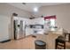 Bright eat-in kitchen features white cabinets, stainless steel appliances, and breakfast bar at 3130 Jorden Crest Ct, Lawrenceville, GA 30044