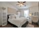 Serene bedroom with vaulted ceiling, plush bedding, vanity, and soft neutral color palette at 3130 Jorden Crest Ct, Lawrenceville, GA 30044