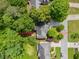 Aerial view showcasing a home surrounded by lush trees and landscaping for privacy and natural beauty at 5105 Tynewick Ne Trce, Roswell, GA 30075