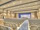 Large auditorium with rows of blue seats facing a stage with curtains and orchestra pit at 5105 Tynewick Ne Trce, Roswell, GA 30075