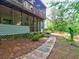 Charming screened porch with adjacent stone walkway leads to a private, landscaped backyard at 5105 Tynewick Ne Trce, Roswell, GA 30075