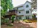 Rear exterior view showcasing a multi-level deck, screened porch, and a well-maintained backyard at 5105 Tynewick Ne Trce, Roswell, GA 30075