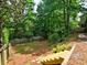 View of spacious, wooded backyard, showing fence and elevated stairs at 5105 Tynewick Ne Trce, Roswell, GA 30075