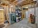 Unfinished basement space with exposed ceiling, concrete floors, and natural light at 5105 Tynewick Ne Trce, Roswell, GA 30075
