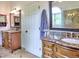 Well-lit bathroom boasts granite countertops, dual vanities, and tiled floors at 5105 Tynewick Ne Trce, Roswell, GA 30075
