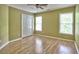 Bedroom featuring neutral paint, hardwood floors, a ceiling fan, and double door closet at 5105 Tynewick Ne Trce, Roswell, GA 30075