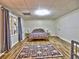 This is a spacious bedroom featuring a decorative rug and a brightly patterned bedspread at 5105 Tynewick Ne Trce, Roswell, GA 30075