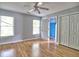 Bedroom with hardwood floors, two windows, double door closet, and neutral paint at 5105 Tynewick Ne Trce, Roswell, GA 30075