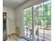 Dining area leading to the wooden deck, with natural light shining through the glass doors at 5105 Tynewick Ne Trce, Roswell, GA 30075