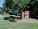Beautiful community entrance with brick signage surrounded by flower beds and mature trees at 5105 Tynewick Ne Trce, Roswell, GA 30075
