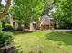 Charming two-story brick home with a well-manicured lawn and mature trees at 5105 Tynewick Ne Trce, Roswell, GA 30075