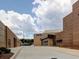Modern school building featuring brick facade, large windows, and landscaped grounds under a cloudy sky at 5105 Tynewick Ne Trce, Roswell, GA 30075