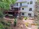 Aerial back exterior view of a two-story home with a deck and patio at 5105 Tynewick Ne Trce, Roswell, GA 30075