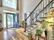 Grand foyer with hardwood flooring, elegant staircase, and decorative front door with sidelights at 5105 Tynewick Ne Trce, Roswell, GA 30075