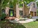 Inviting brick home featuring a decorative front door, lush landscaping, and a two-car garage at 5105 Tynewick Ne Trce, Roswell, GA 30075