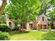 Charming two-story brick home with a well-manicured lawn and mature trees enhancing its curb appeal at 5105 Tynewick Ne Trce, Roswell, GA 30075