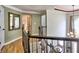 Second floor hallway with hardwood floors and view of chandelier below at 5105 Tynewick Ne Trce, Roswell, GA 30075