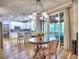 Kitchen and breakfast area, features modern lighting, stainless appliances and access to screened porch at 5105 Tynewick Ne Trce, Roswell, GA 30075