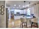 Modern kitchen with white cabinets, stainless steel appliances, granite countertops, and hardwood floors at 5105 Tynewick Ne Trce, Roswell, GA 30075