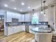 Well-lit kitchen featuring white cabinets, modern appliances, granite countertops, and an open layout at 5105 Tynewick Ne Trce, Roswell, GA 30075