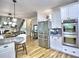 Bright eat-in kitchen features stainless steel appliances and white cabinetry at 5105 Tynewick Ne Trce, Roswell, GA 30075