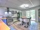This is a kitchen featuring a stainless steel oven, island with seating and sliding glass doors to the exterior at 5105 Tynewick Ne Trce, Roswell, GA 30075