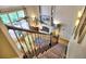 Open staircase with view of the living room and fireplace at 5105 Tynewick Ne Trce, Roswell, GA 30075