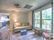 Bright living room with ample natural light, stylish decor, and open access to the kitchen at 5105 Tynewick Ne Trce, Roswell, GA 30075