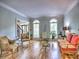 Inviting living room featuring hardwood floors, arched windows, and comfortable seating with elegant decor at 5105 Tynewick Ne Trce, Roswell, GA 30075