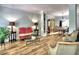 Spacious living area with hardwood floors, decorative seating, and an open view to the dining room at 5105 Tynewick Ne Trce, Roswell, GA 30075