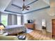 Spacious primary bedroom featuring tray ceiling, hardwood floors, and lots of natural light at 5105 Tynewick Ne Trce, Roswell, GA 30075