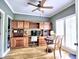 Elegant home office with custom wood built-ins, a ceiling fan, and natural light from shuttered windows at 5105 Tynewick Ne Trce, Roswell, GA 30075