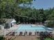 Community pool area with ample seating, a gazebo, and a surrounding fence at 5105 Tynewick Ne Trce, Roswell, GA 30075