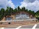 Stone sign reading 'Alan C. Pope High School' nestled in a landscaped area with evergreen trees at 5105 Tynewick Ne Trce, Roswell, GA 30075
