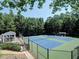 Community tennis courts with lighting, fencing, and a nearby gazebo for relaxing at 5105 Tynewick Ne Trce, Roswell, GA 30075