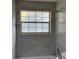 Bathroom featuring a window with decorative window panes and neutral tile at 76 Burbank Dr, Atlanta, GA 30314