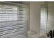 Bathroom featuring a shower/tub combo with a window and a decorative striped shower curtain for added privacy at 76 Burbank Dr, Atlanta, GA 30314