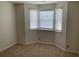 Well-lit bedroom with neutral walls, carpet flooring, and a bay of windows with blinds for ample natural light at 76 Burbank Dr, Atlanta, GA 30314