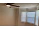 Well-lit bedroom featuring a modern ceiling fan and three windows for natural light at 76 Burbank Dr, Atlanta, GA 30314