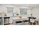 Modern kitchen features white cabinets, stainless steel appliances, and a cozy breakfast nook at 76 Burbank Dr, Atlanta, GA 30314