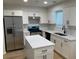 Modern kitchen features white cabinets, stainless steel appliances, and a kitchen island at 76 Burbank Dr, Atlanta, GA 30314