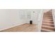 Bright living room features hardwood floors, high ceilings, and a staircase to the second floor at 76 Burbank Dr, Atlanta, GA 30314