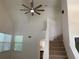 Open living room with high ceilings, staircase, ceiling fan, and abundant natural light at 76 Burbank Dr, Atlanta, GA 30314
