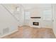 Spacious living room featuring a modern fireplace with a marble surround and hardwood floors at 76 Burbank Dr, Atlanta, GA 30314