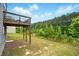 A spacious backyard featuring a wooden deck supported by posts provides an expansive outdoor space at 7698 Hansel Ln, Lithonia, GA 30058