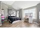 Stylized bedroom includes a vanity and makeup station and an abundance of natural light at 7698 Hansel Ln, Lithonia, GA 30058