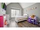 Charming bedroom with bright decor featuring wood floors, window, desk and furnishings at 7698 Hansel Ln, Lithonia, GA 30058